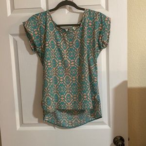 teal and pink patterned blouse